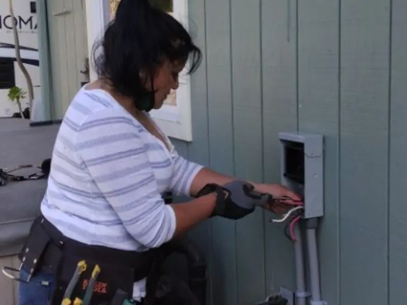Licensed electrician wiring an exterior subpanel in Floresville